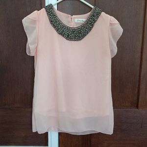 Pink blouse with embellished neckline